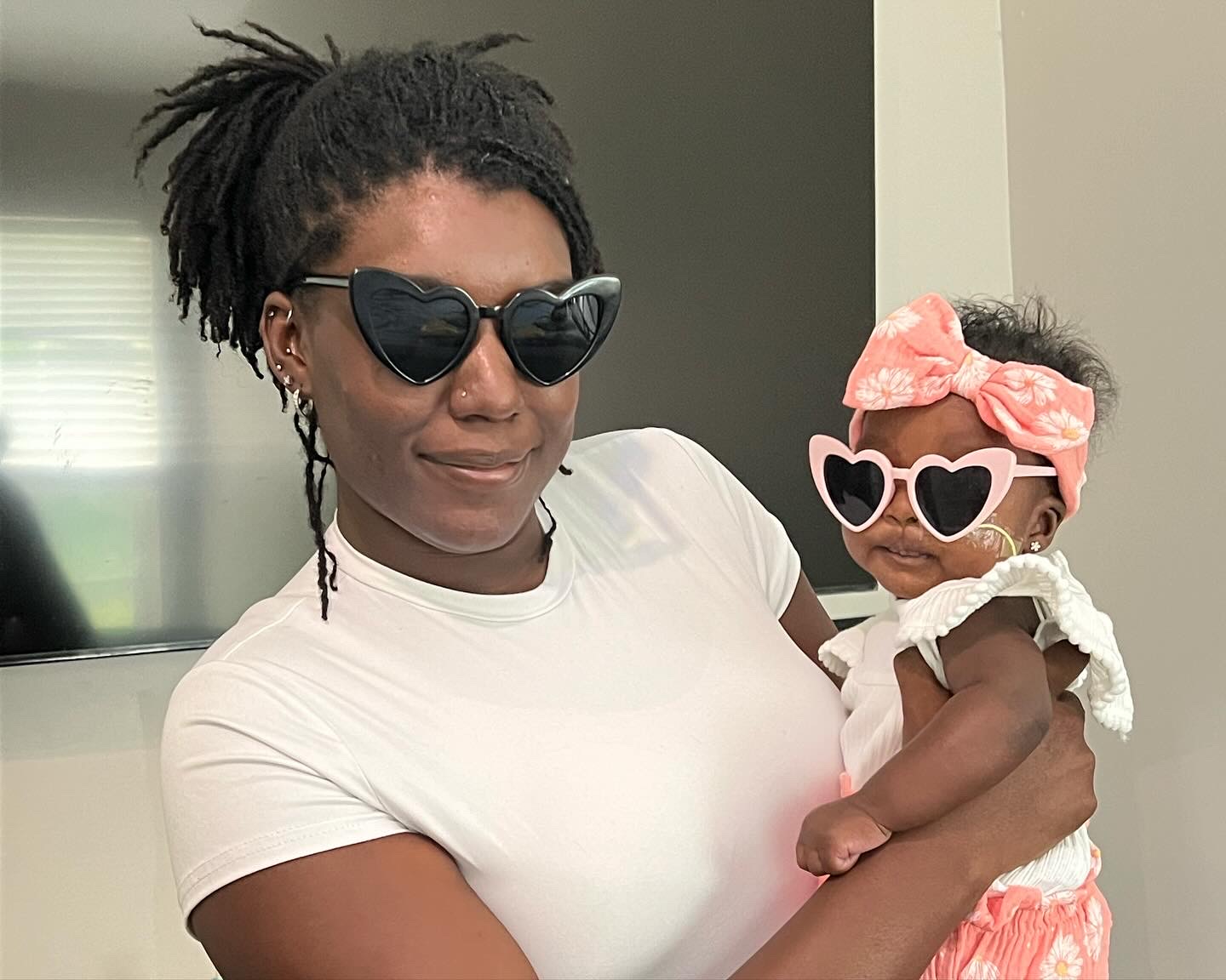 Mom and baby Renee with matching heart-shaped sunglasses